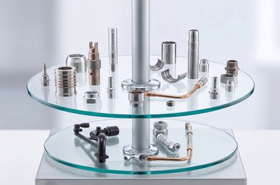 glass two tier shelf that displays manufacturing nuts and bolts